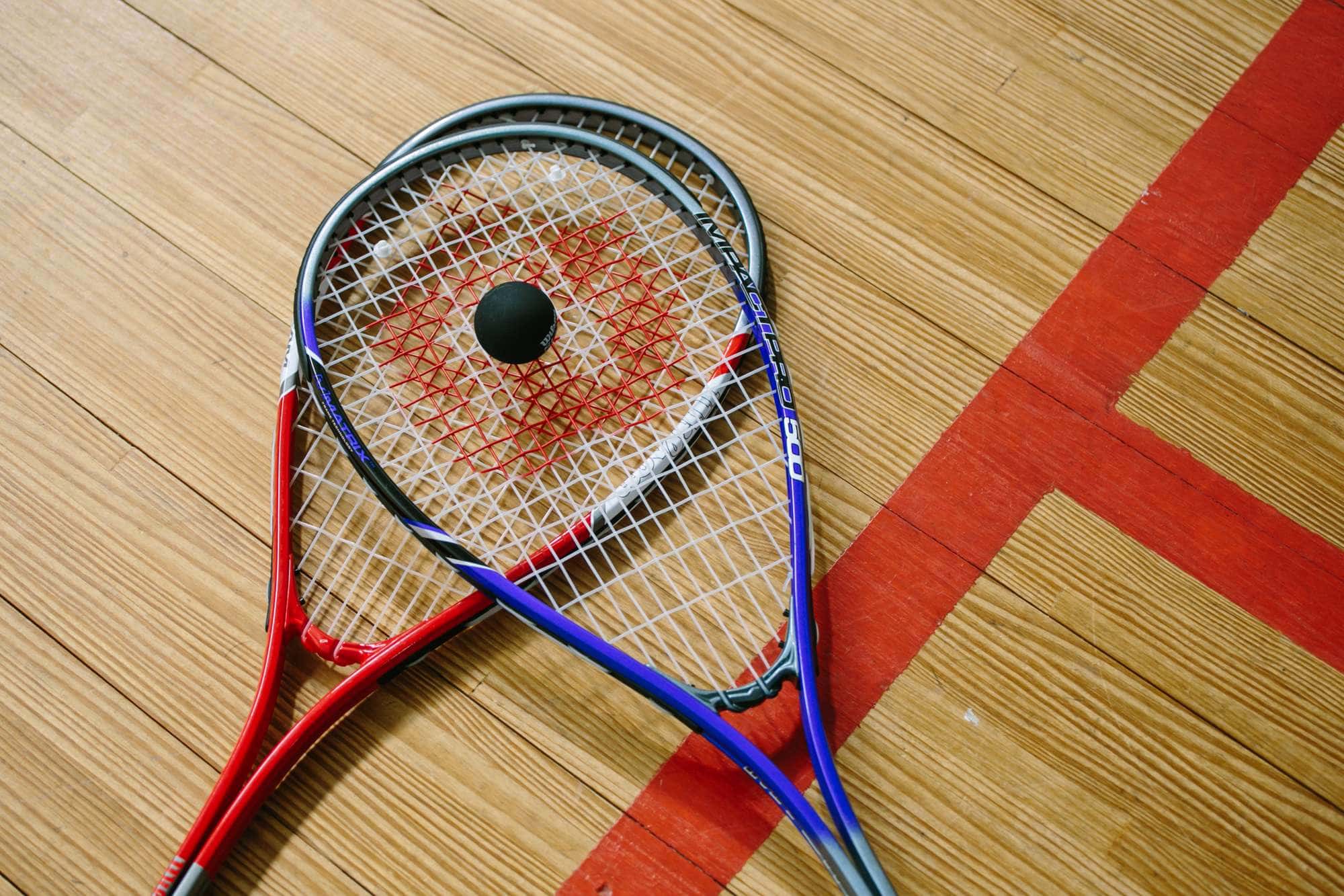 Squash racquets and a ball on a court at The Lake Club Benoni